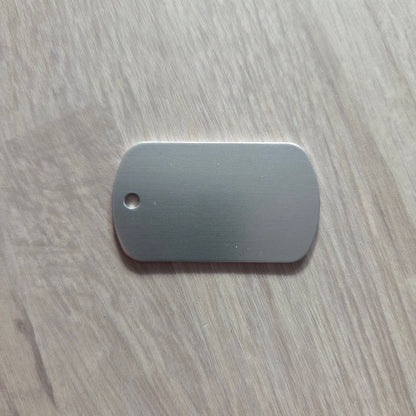 Metallic dog tag on a wooden surface