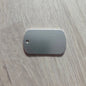 Metallic dog tag on a wooden surface