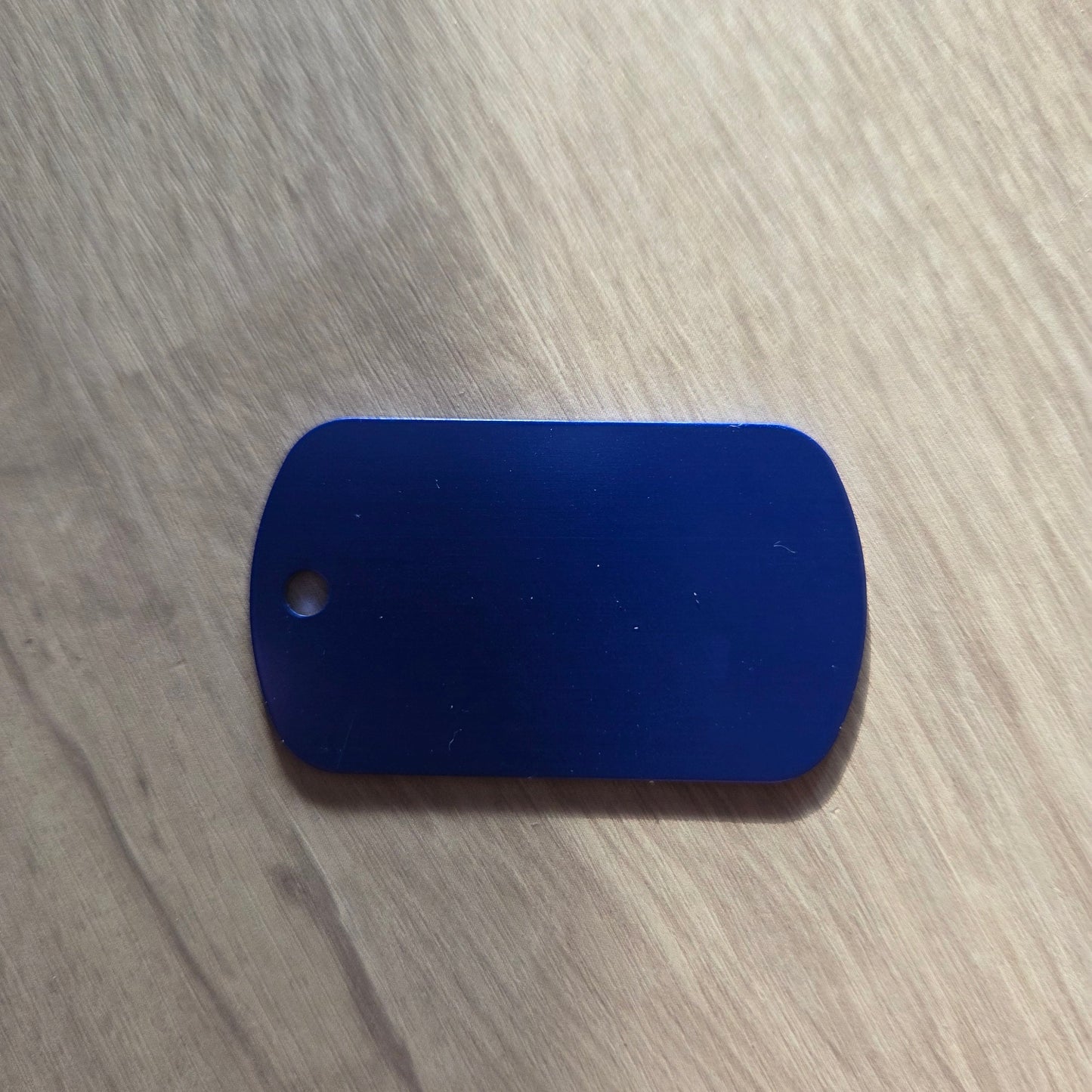 Blue rectangular object on a light wooden surface