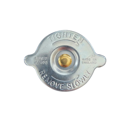 Metal radiator cap with 'Tighten' and 'Remove Slowly' text on a white background