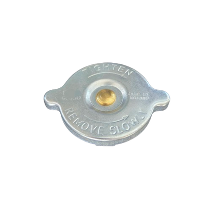 Metal radiator cap with text on a white background
